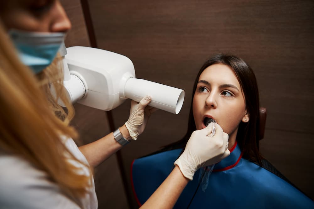 woman at the dentist doing an x ray 