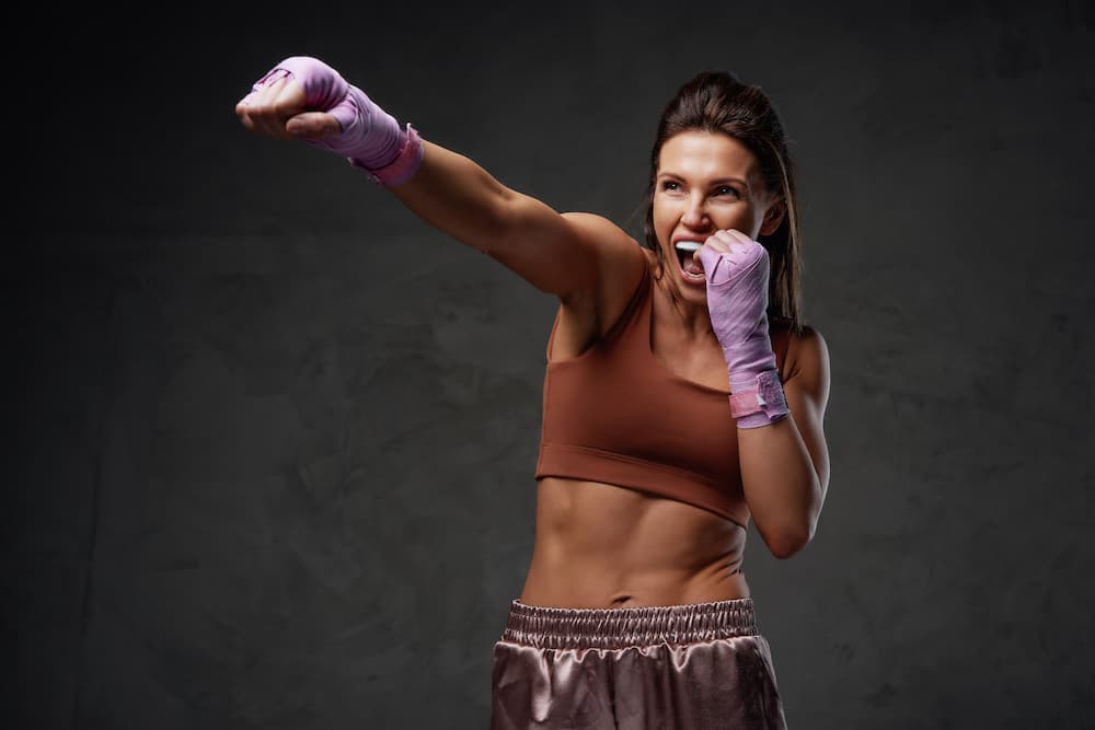 woman boxing with sports guard